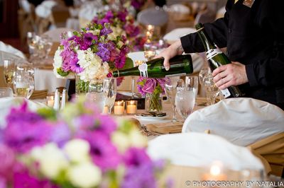 Champagne being poured at an outdoor wedding.