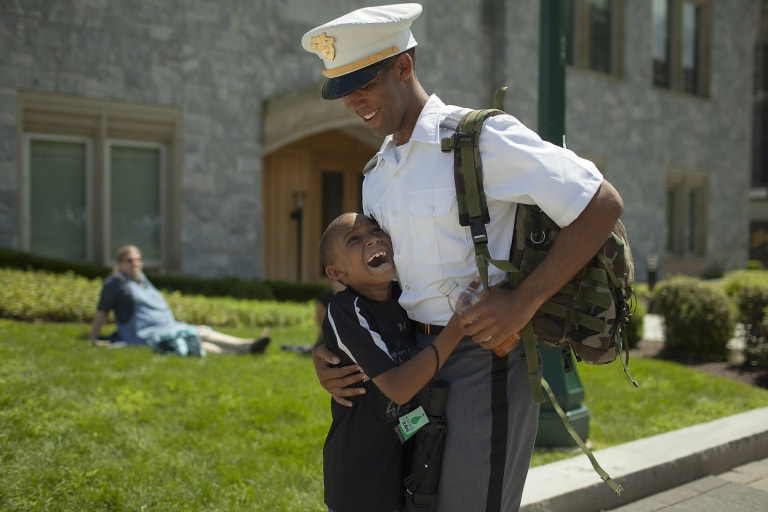 West Point grad hugging his son