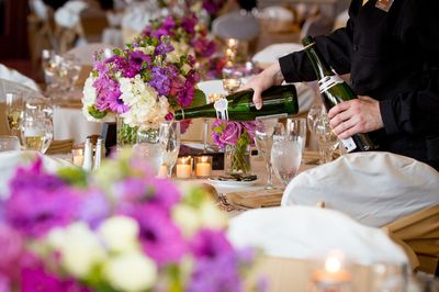 Man pouring champagne at wedding reception