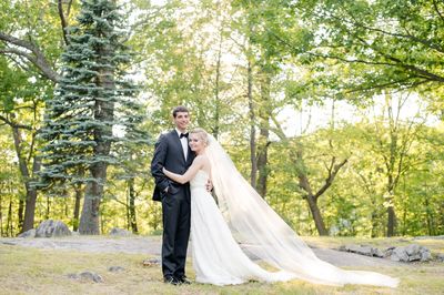 Bride and groom in forested landscape