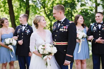 Bride looking lovingly at her groom, who is in military uniform