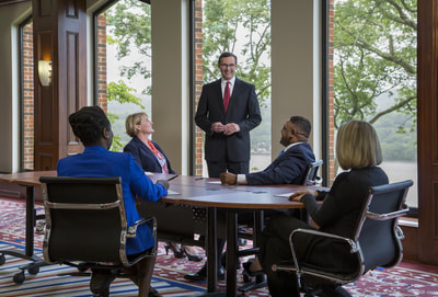 Five people holding a business meeting