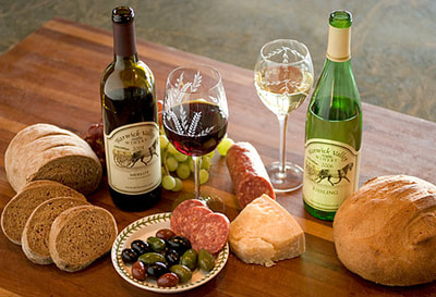 An assortment of wine, cheeses and bread